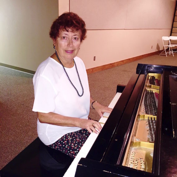 Piano Teacher Sofia Friedman seated at piano